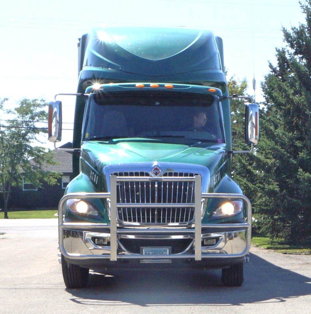 a green truck parked on a road